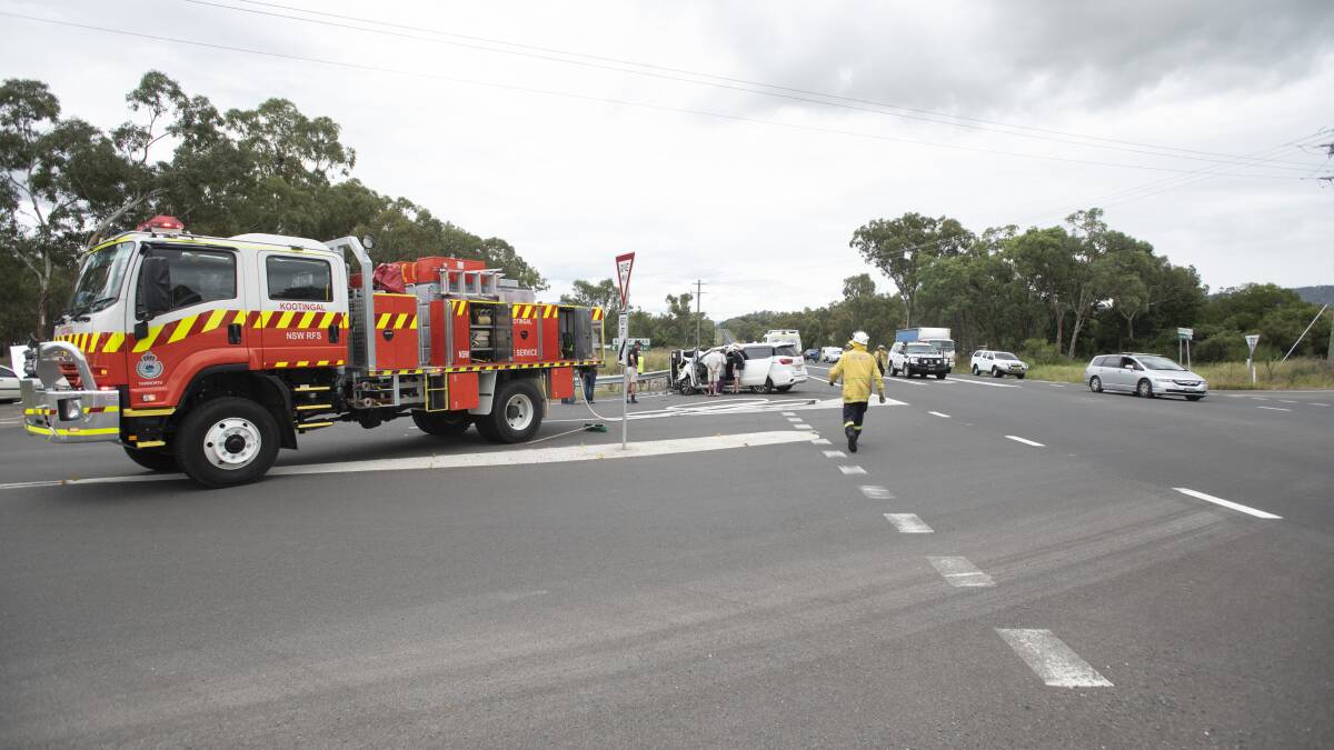Emergency services at the scene of the crash at the New England Highway intersection, last year. Picture by Peter Hardin