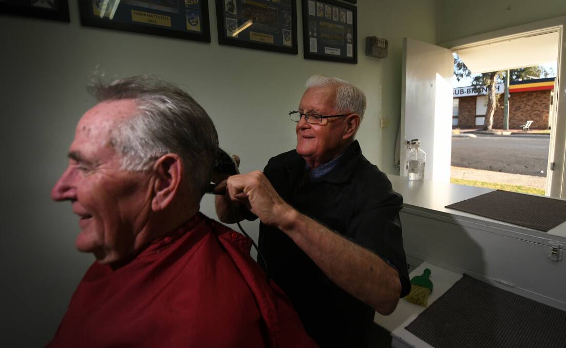 MATES: Jim Phillips cut long-term client John Taggart's hair one last time, before he puts down his scissors for good. Photo: Gareth Gardner 020720GGA06