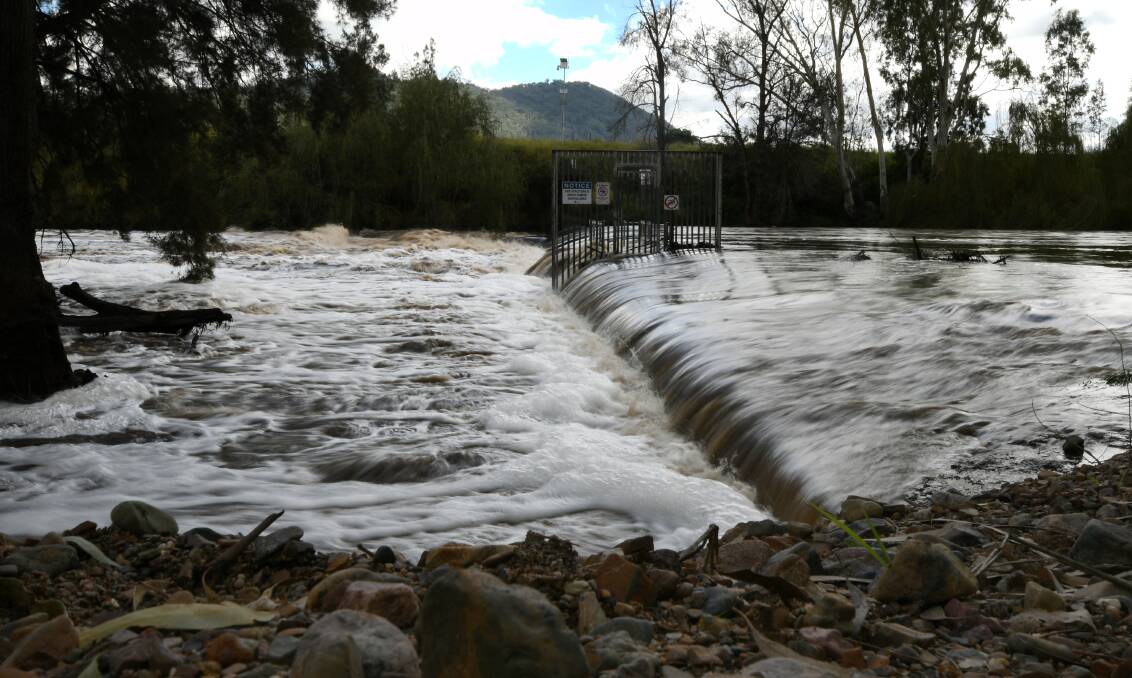 FLOODED: A raging Namoi River surged over the weir at Manilla and gushed into Lake Keepit. Photos: Gareth Gardner