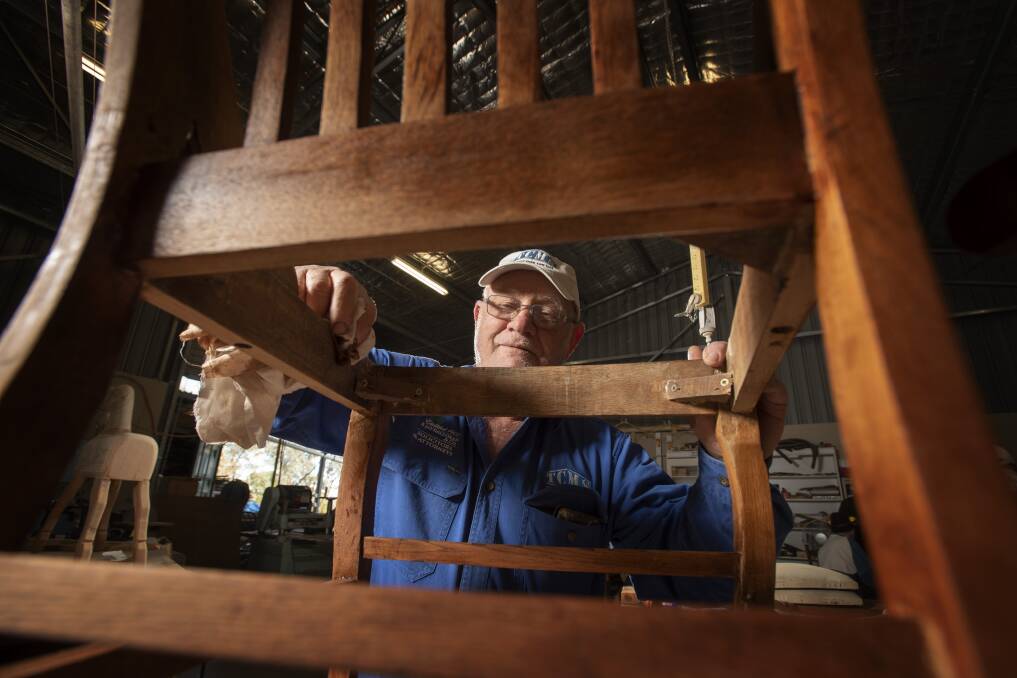 ON THE GRIND: Rob Hardie working on a wooden chair after the Tamworth Community Men's Shed reopened its doors last week. Photo: Peter Hardin 180620PHA038