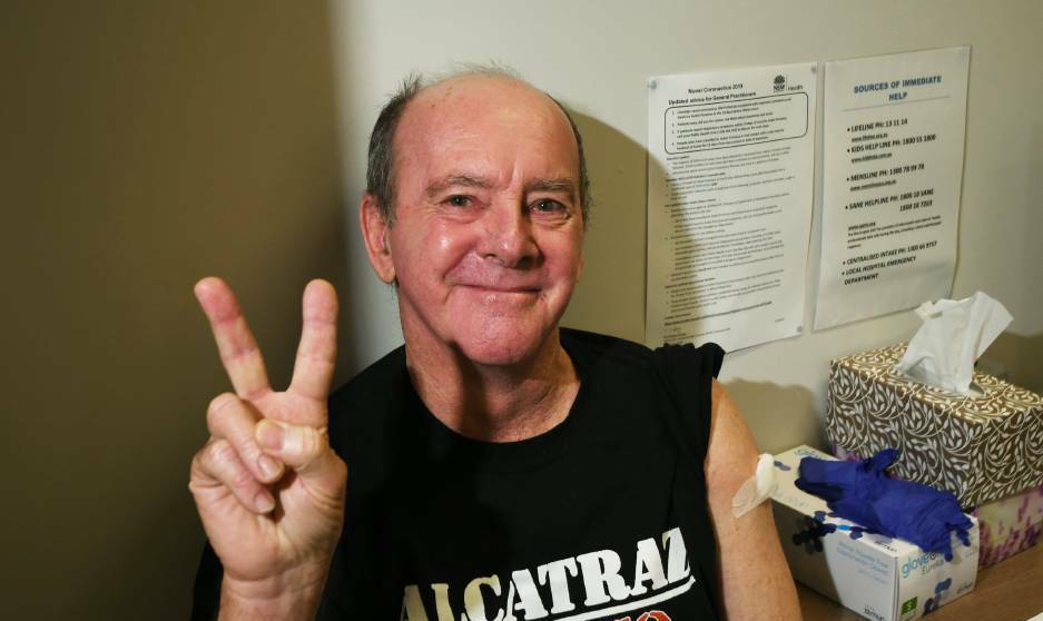 JABBED: Tamworth's Barry Bonarius does the 'V-Day' vaccination symbol after his routine appointment became one for the history books. Photo: Gareth Gardner
