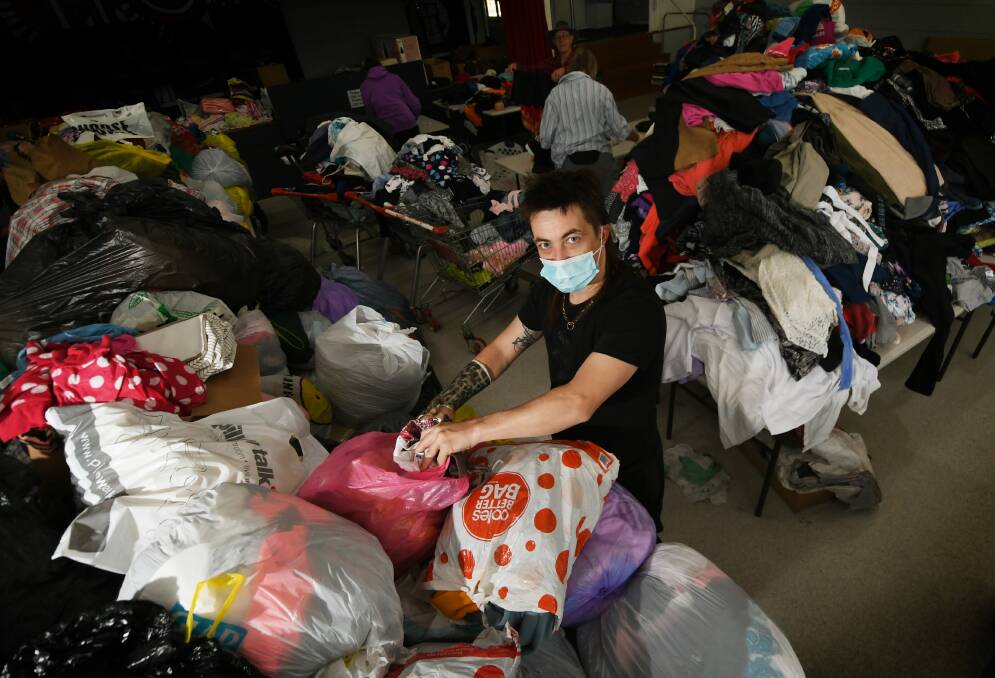 'LIKE CHRISTMAS': Jesse Howard and his colleagues at the Salvation Army have been working hard to sort through a flood of clothing donations. Photo: Gareth Gardner 020920GGA04