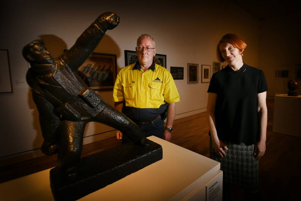 REFLECTING: The Australian War Memorial's George Bailey and gallery director Bridget Guthrie, with a work called 'Bomb thrower'. Photo: Gareth Gardner