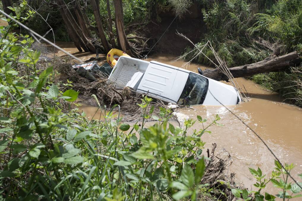Ute washed down creek after trying to drive through floodwater. Photos: Peter Hardin
