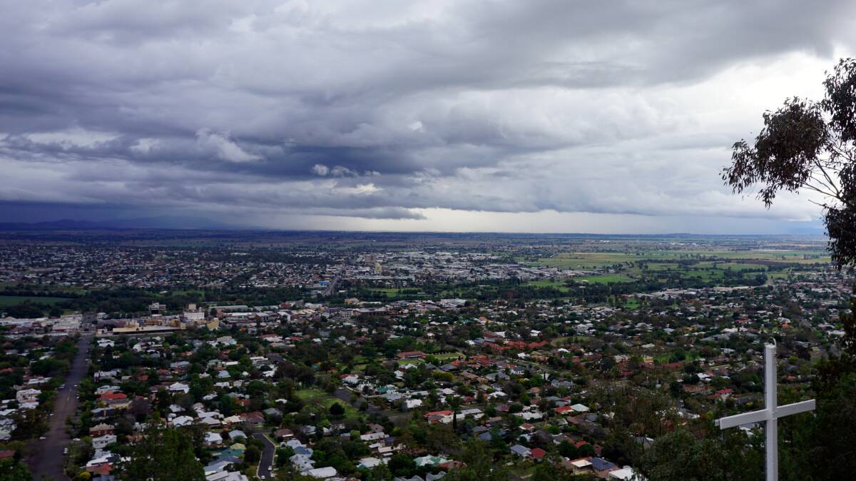 POURING: Rain clouds from the Tamworth lookout on Sunday. Photo: Gaye Johnson-Weeks