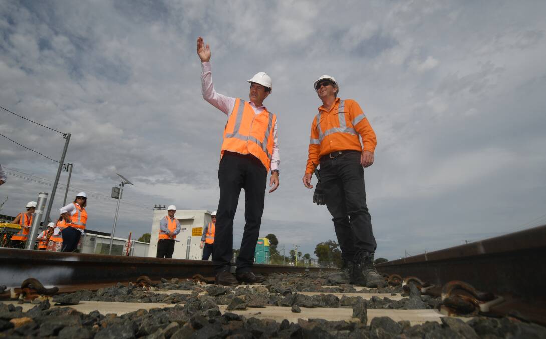 ON TRACK: Kevin Anderson and John Holland construction manager Heath Campbell on the brand-new rail line. Photo: Gareth Gardner 