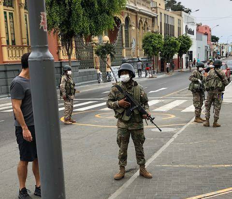 Pervuian soldiers stand guard outside a supermarket. The South American country is under martial law. 