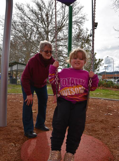 Swings and roundabouts: Grandmother Peg Taylor, with Willow Shaw at a Tamworth park on a wet Sunday afternoon. Photo: Andrew Messenger