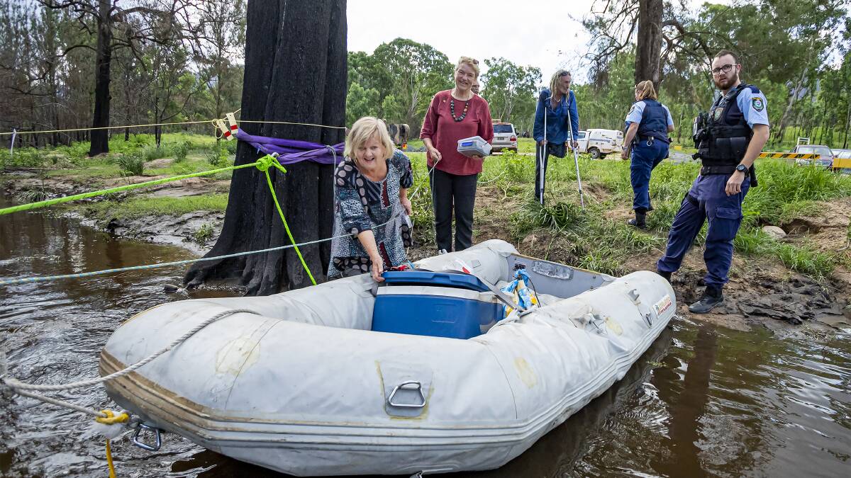 Carol Sparks helps send supplies into Wytaliba, cut off by flood waters. Picture: Tony Grant