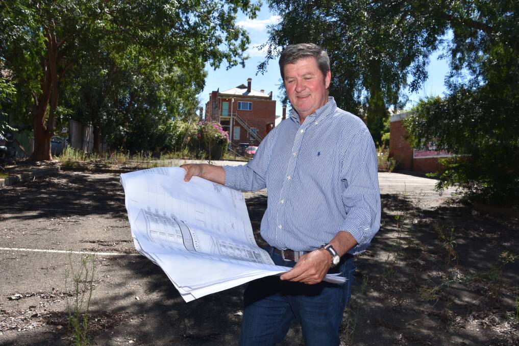 BIG DREAMS: Campbell McIntosh looks over plans at the site of what will be the city's first big apartment block, on Dowe Street. Photo: Andrew Messenger 