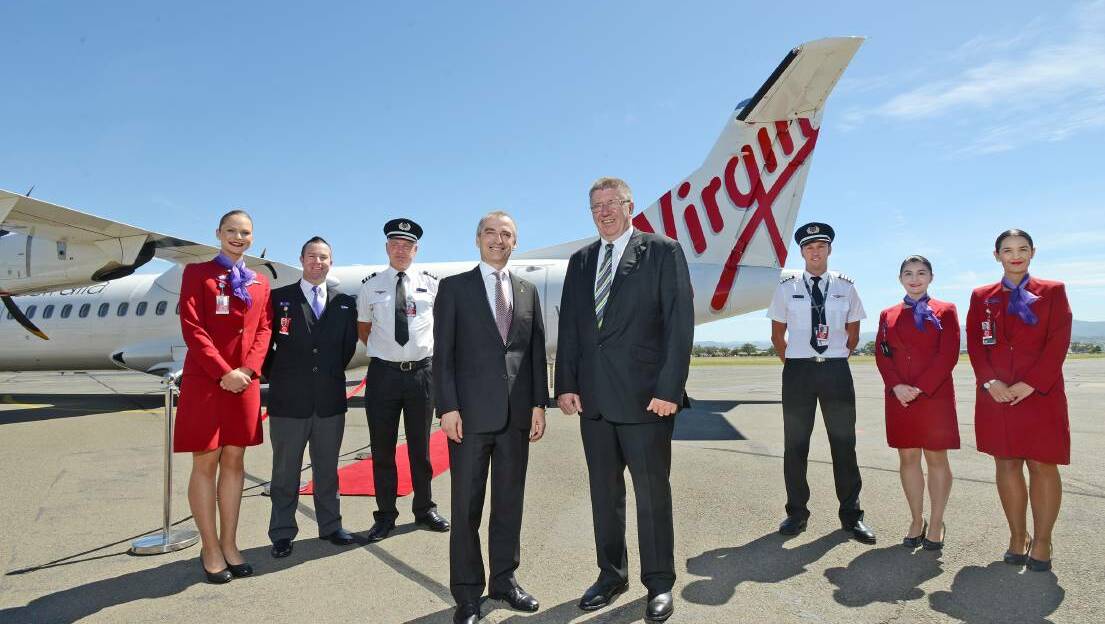 HAPPIER TIMES: former Virgin Australia chief executive John Borghetti and Tamworth Regional Council mayor Col Murray with flight staff at Tamworth airport in 2019. Photo: Barry Smith

