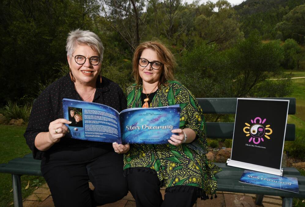 EXTRAORDINARY STORY: Jodie Herden and Mel Armstrong show off a copy of their first book together, Star Dreaming. Photo: Gareth Gardner 