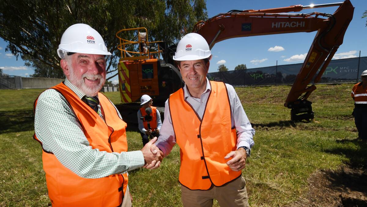 GROUND BROKEN: Tamworth mayor Russell Webb and water minister Kevin Anderson throw the first sod for the new pipeline project. Photo: Gareth Gardner