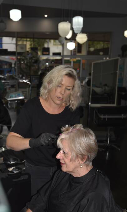 SHIFTING SANDS: Babette Hardman at Tamworth hairdresser Illegal Lengths in Hair thought her business would have to close yesterday. Today she colours the hair of Veronika Morgan. Photo: Andrew Messenger 