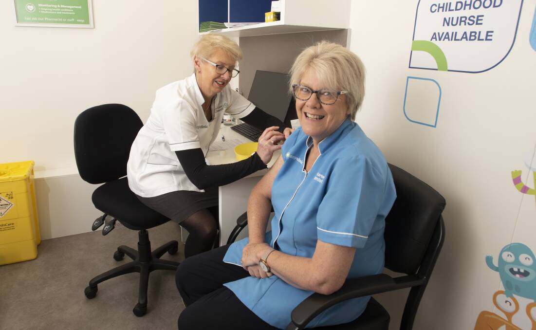 Karen Carter gives Kate Frend a flu vaccine injection. Photo: Peter Hardin