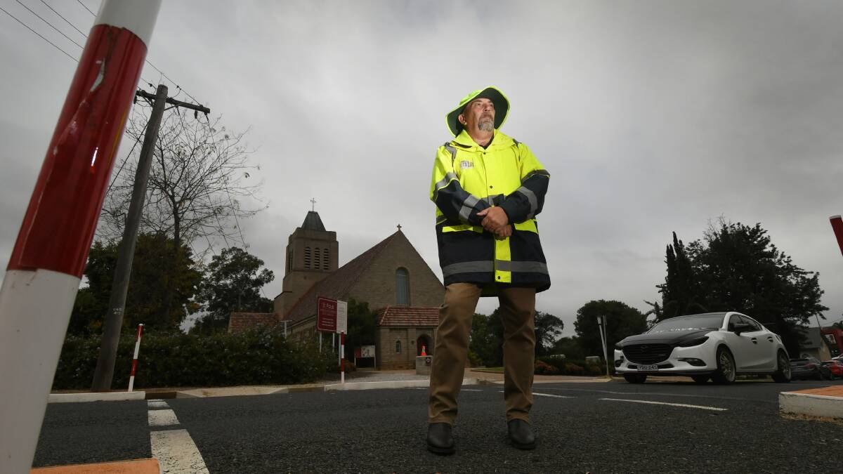 SAFETY WORRIES: Union organiser Stephen Mears (dressed as a crossing guard) said the employees face heat, hail and rain without shade or cover. Photo: Gareth Gardner 