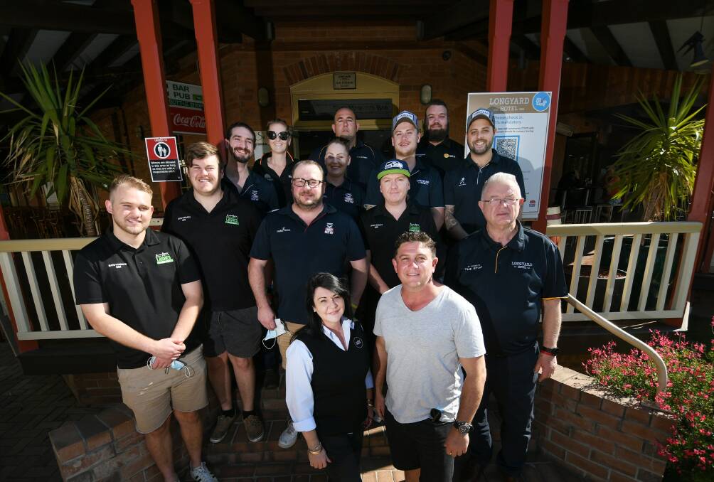 TAKING POWER: Craig Power and Tierzah Douglas (front) with the staff of the Longyard Hotel celebrate the new formal owners of the Pub Group hotels. Photo Gareth Gardner 081021GGG01