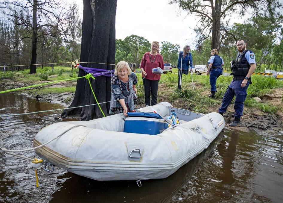 WASHED OUT: Glen Innes Mayor Carol Sparks and Greens Senator Janet Rice help send food and medical supplies to Wytaliba in February. Photo: Tony Grant.