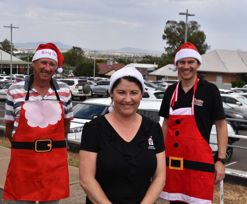 SEASONS GREETINGS: Tamworth Santa Pub Crawl organiser Phil Knight with founder Chris Watson (right) and Ronald McDonald House Manager Rhiannon Curtis. Photo: Andrew Messenger
