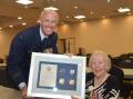 CENTENARIAN: RAAF acting sergeant Val Smith (right) receives an award commemoraing her 100th birthday from Flight Lieutenant Dave Slattery. Photo: Andrew Messenger 