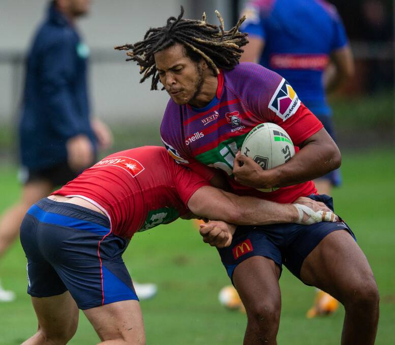 Hair-raising: English recruit Dominic Young drops the shoulder into a teammate at Knights training yesterday as the players prepare for Saturday's trial against Melbourne in Albury. Picture: Marina Neil. 