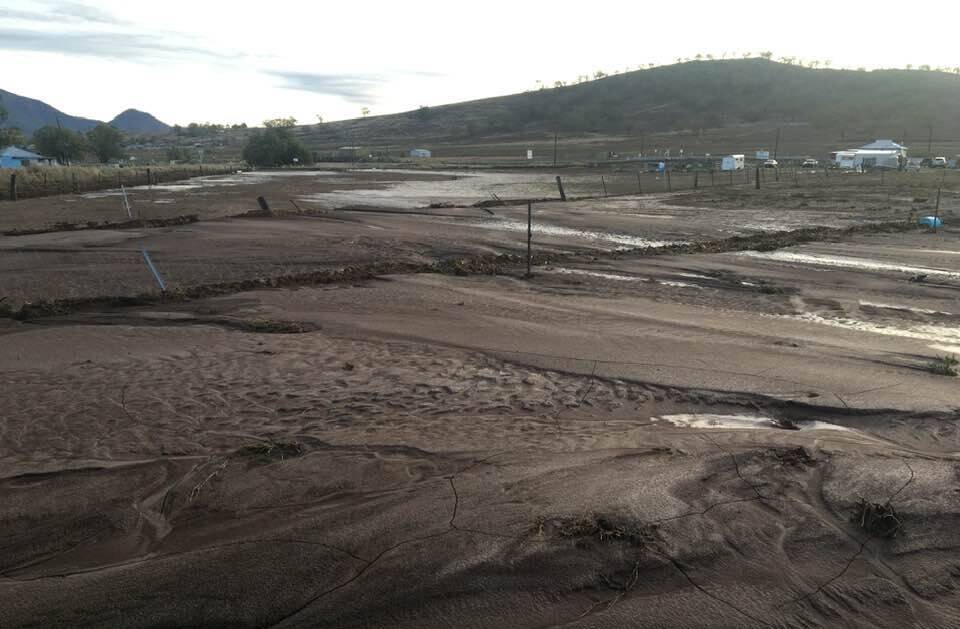 Silt and dirt cover paddocks off Werris Creek Road after storm rain washed through paddocks, knocking down fences and causing hundreds of thousands of dollars damage to rail, road and water infrastructure. Photo by Kylie Raines.