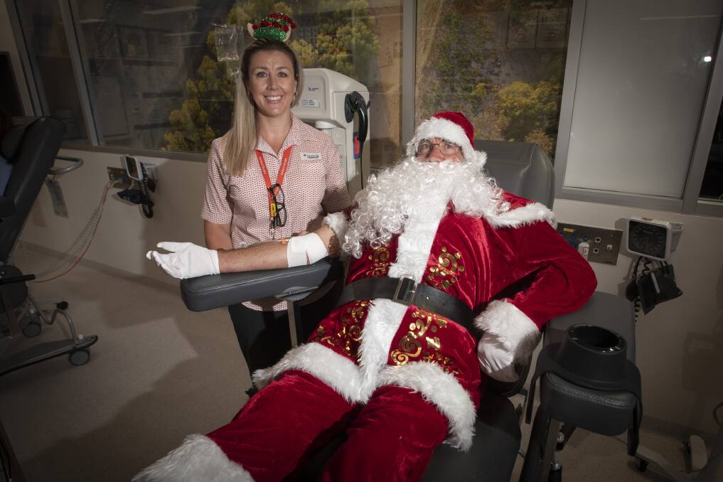 GIVING: Santa gives the gift of life this Christmas at Tamworth Lifeblood with Lifeblood's Janine Crowell, who is encouraging more people to do the same. Photo: Peter Hardin 