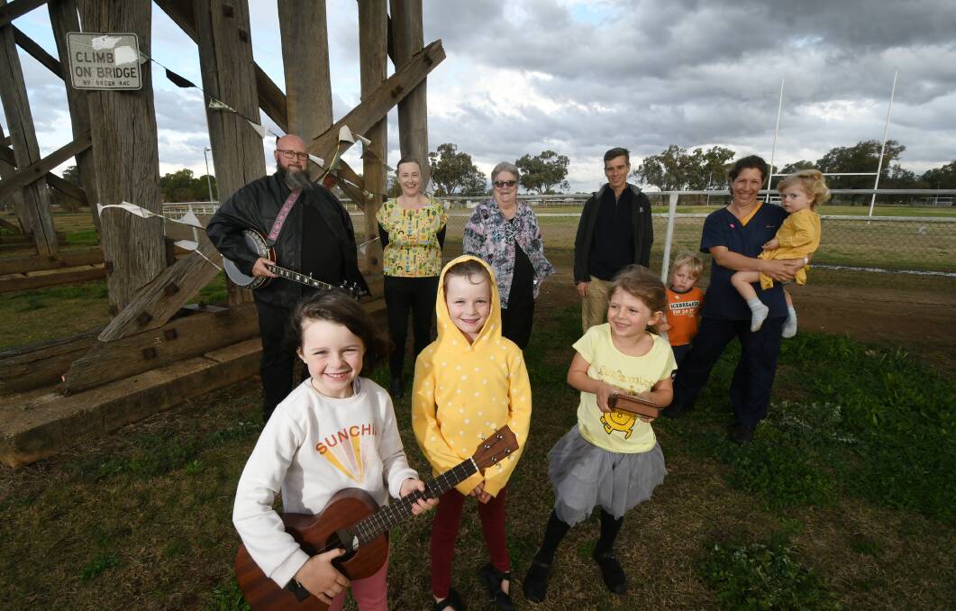 STRONG COMMUNITY: Brad Pilon, Emma Stilts, Michelle Eggins, John Calokerinos and Fiona Kelly with Jesse Kelly, 4, and Alice Kelly, 2. Front: Jewls Stilts, 5, Amelia Stilts, 7, and Gwin Kelly, 6. Photo: Gareth Garder 150721GGE01