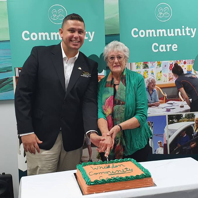 OPEN: Councillor Marc Sutherland and Jan Donaghoe, whose husband is a Whiddon Community Care client, cut the cake. Photo: Supplied 