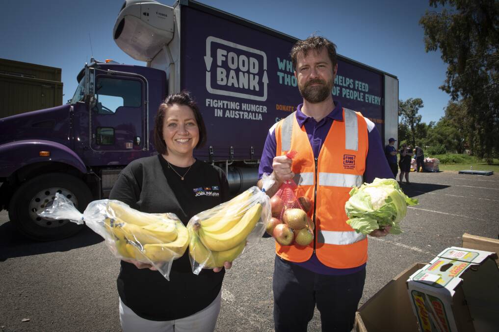 FOOD RELIEF: Joblink Plus community engagement coordinator Katrina Higgins and Foodbank's Adam Loftus in Gunnedah. Photo: Peter Hardin