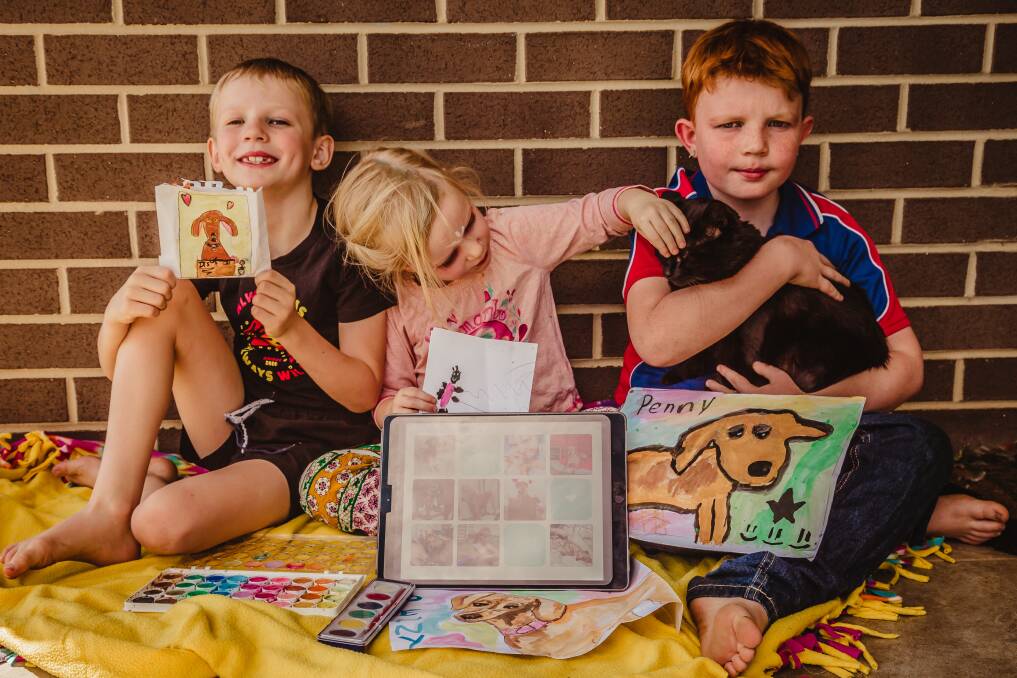 GET CREATIVE: Landon, 7, Frankie, 4 and Clayton, 8 painted their dog Penny that recently passed away. Photo: Tess Reading 