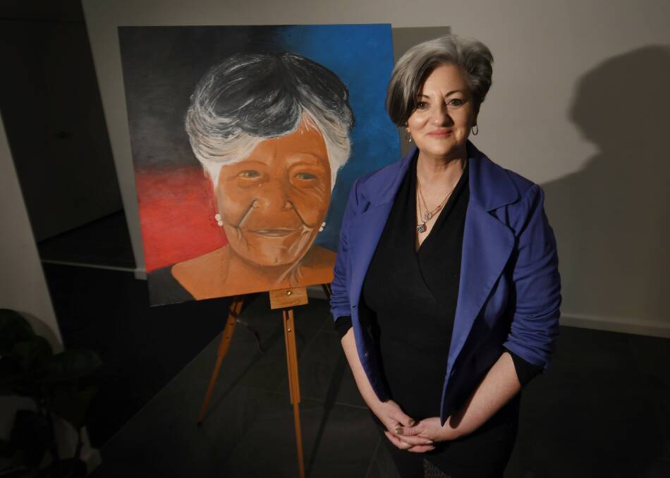 Regional Unlimited chair Deb Maes with the commemorative portrait of Aunty Yvonne Kent. Picture by Gareth Gardner
