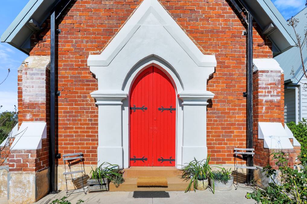 HISTORIC: The church's stained glass windows and timber doors have been restored, while seamlessly fusing with the original brick. Photo: Supplied