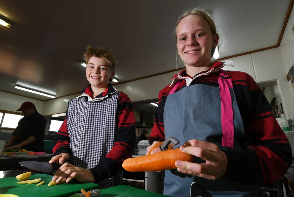 FOOD FUN: Jack Siemer and Jessica Mashford enjoying their chance to do some food technology in person. Photo: Gareth Gardner 300621GGB02