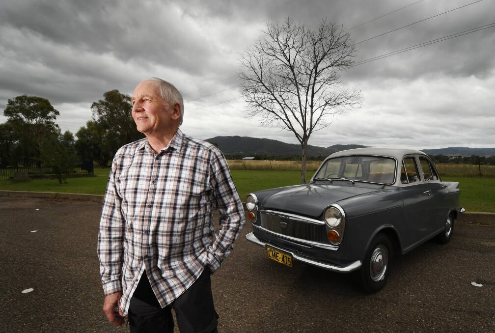 FAMILAR SOUND: Local radio legend Phil Corbett alongside his 1961 Austin Lancer, which even features a promotional sticker from the first ever Tamworth Country Music Festival. Photo: Gareth Gardner