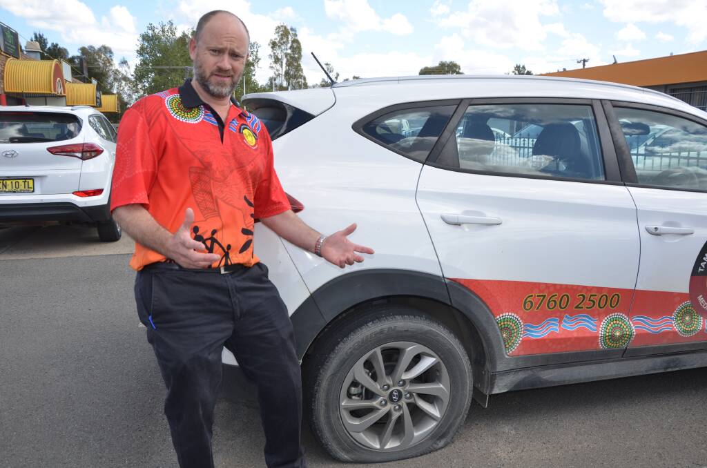 VEHICLE VANDALS: Tamworth Aboriginal Medical Service director Damion Brown is confused as to why someone would slash tyres. Photo: Cody Tsaousis