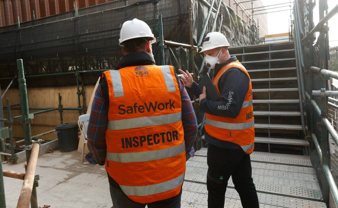 CRACKDOWN: SafeWork NSW inspectors during an unannounced safety audit at a Newcastle West construction site. The inspection was part of a week-long Hunter blitz that started on Tuesday. Picture: Max Mason-Hubers 