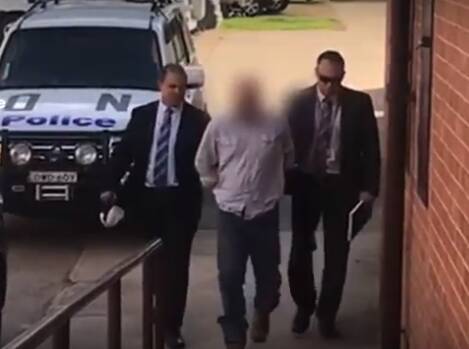 Charged: Detectives from Tuggerah Lakes Police District lead James Scott Church into Inverell Police Station on Thursday. Photo: NSW Police