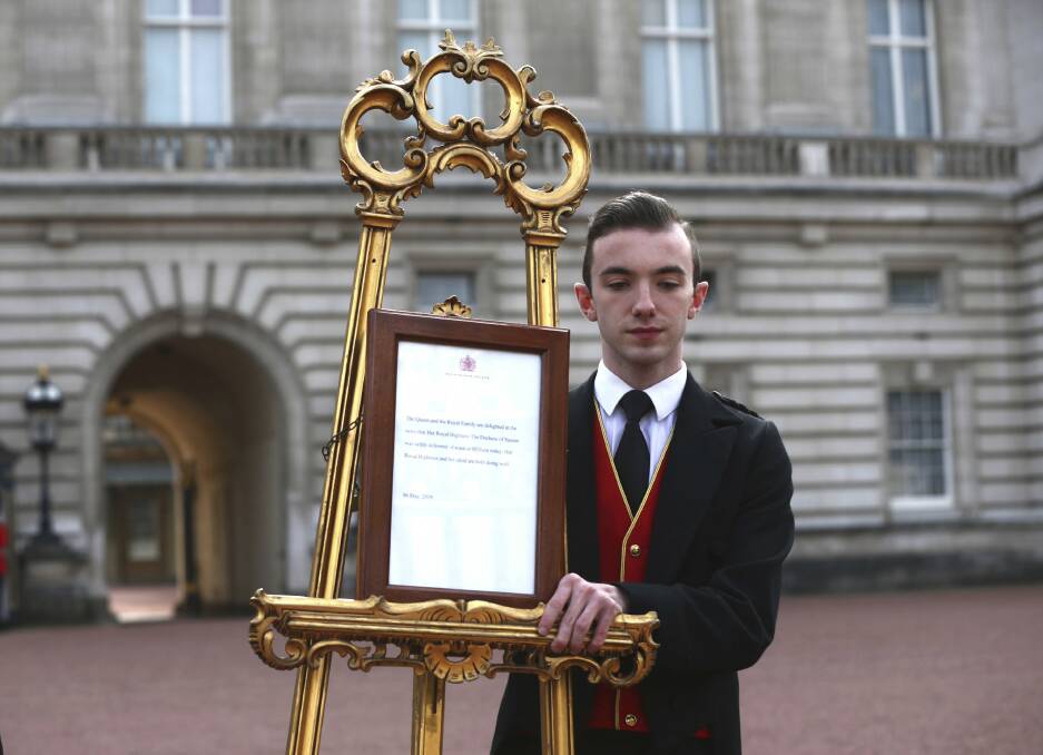 Footmen Stephen Kelly brings out the easel in the forecourt of Buckingham Palace to formally announce the birth of a baby boy to Britain's Prince Harry and Meghan, the Duchess of Sussex. Picture: AP