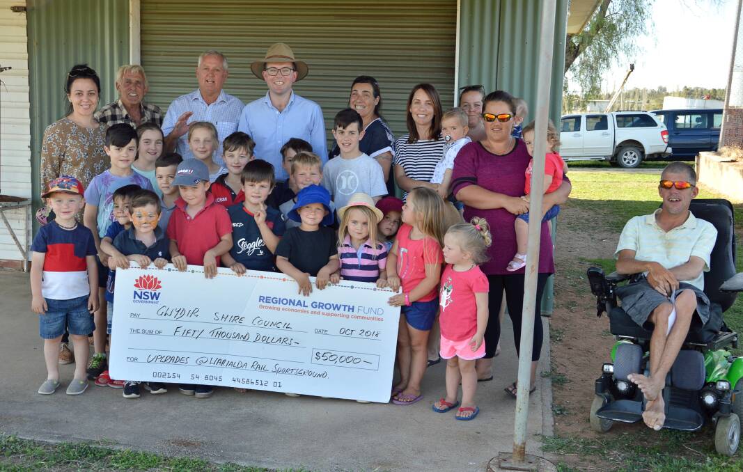 Warialda Rail community members and a few of the local youngsters using the popular grounds celebrate a funding boost.