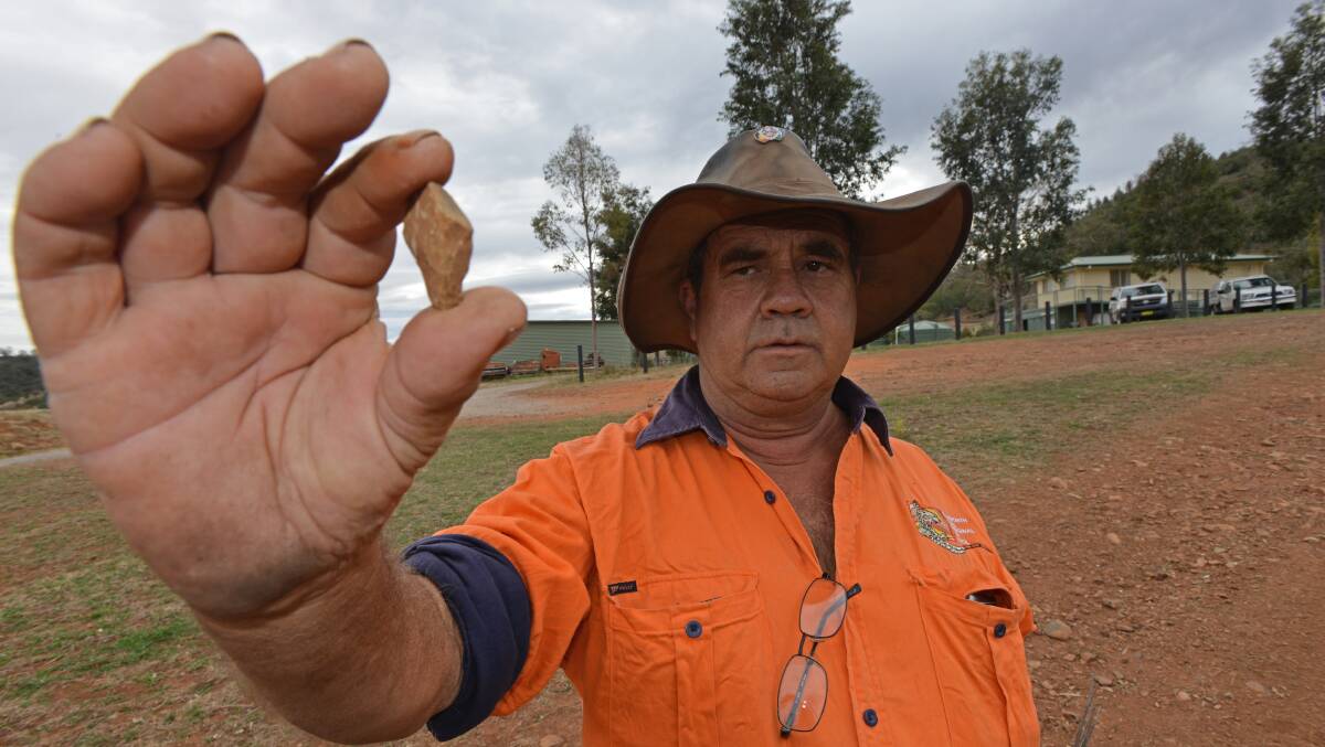 UNCOVERED: Anaiwan tracker Don Fermor holds a stone artefact found at Victoria Park. Photo: Ben Jaffrey