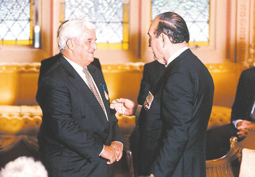 BUSINESSMAN: Keith Singh, left, pictured in 1996 being made a Member of the Order of Australia.