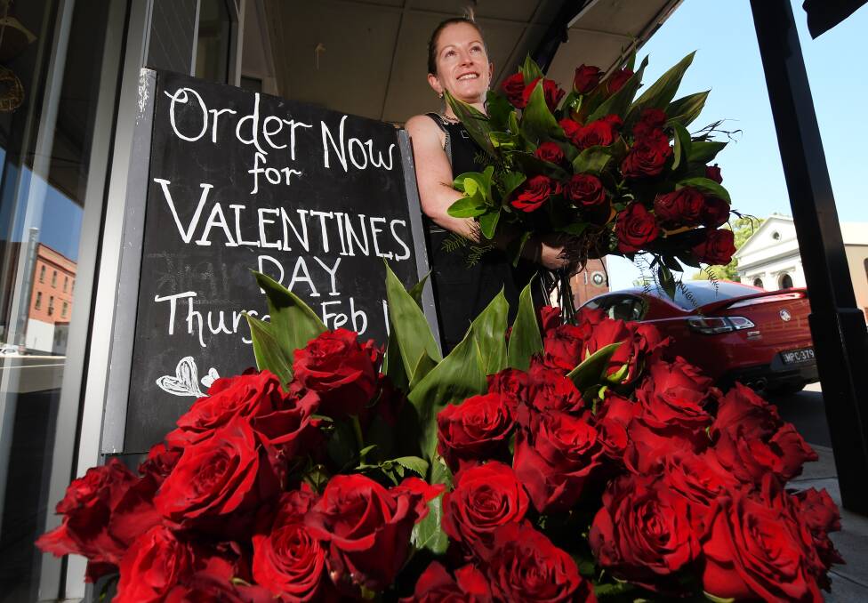 LOVE IS IN THE AIR: Designer Bunches co-owner Eliza Fagan prepares roses for Valentine's Day. Photo: Gareth Gardner