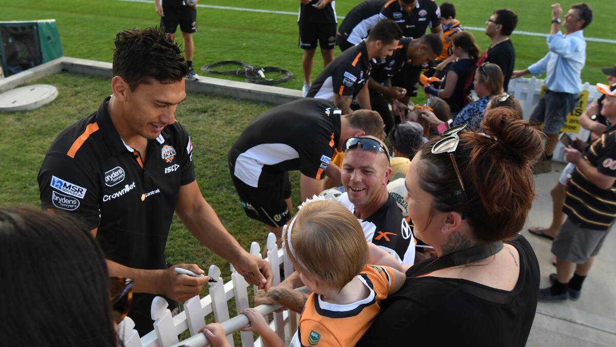 TIGER TOWN: Wests Tigers fans lined up to get an autograph from their favourite players at the 2019 game. Photo: Gareth Gardner