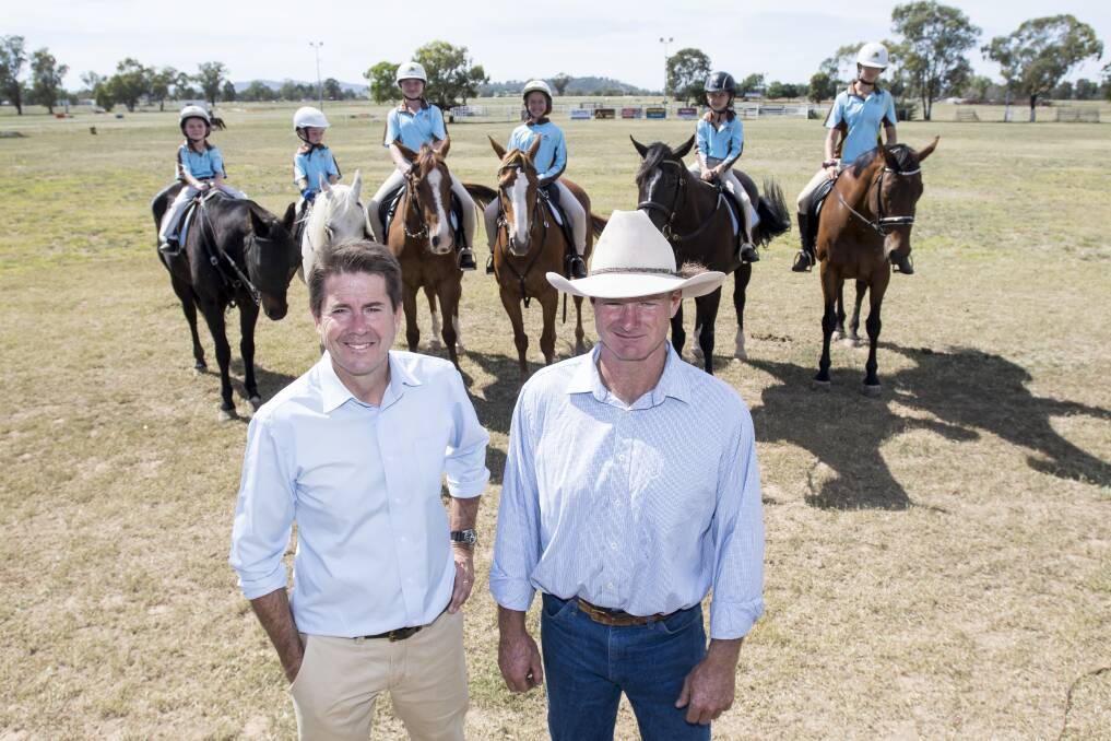 ALL SMILES: Tamworth MP Kevin Anderson with Tamworth Pony Club president Victor Collett with kids at the club excited to get cracking on upgrades. Photo: Peter Hardin