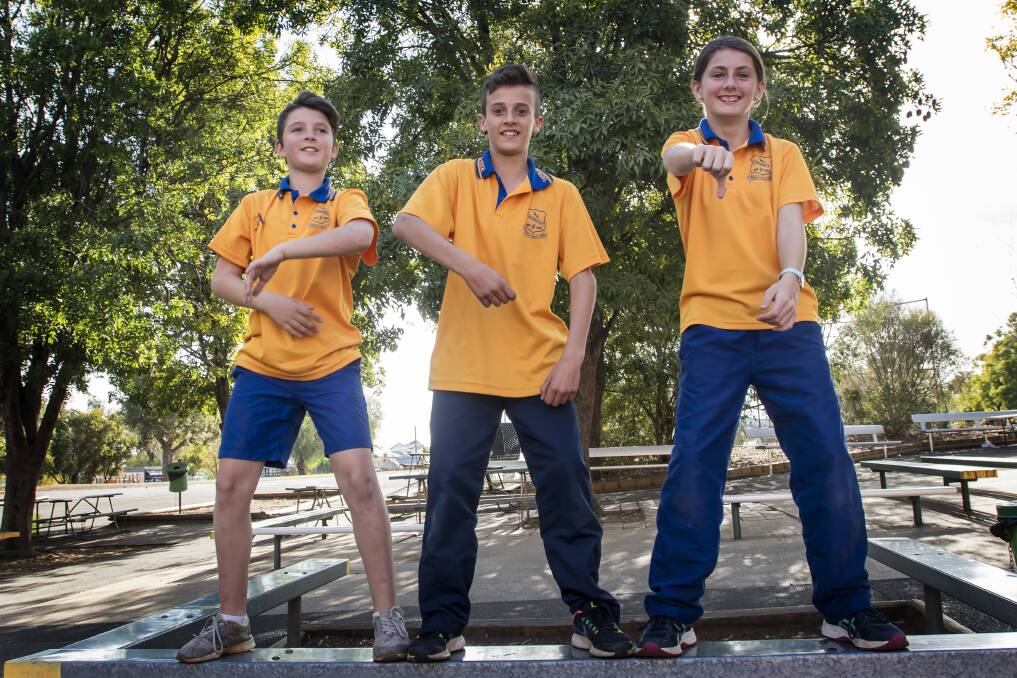 CARVE IT UP: Tamworth Public School Year 6 students Deagan Sippel, Noah Brown and Bindi Coleborn show off their moves ahead of the rain dance on Friday. Photo: Peter Hardin