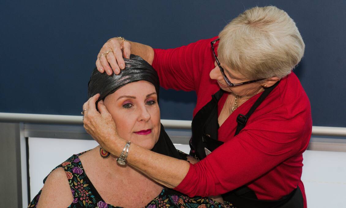 LEND A HAND: Margaret Rock helps Leanne Rushby tie a head scarf. Photo: Peter Hardin