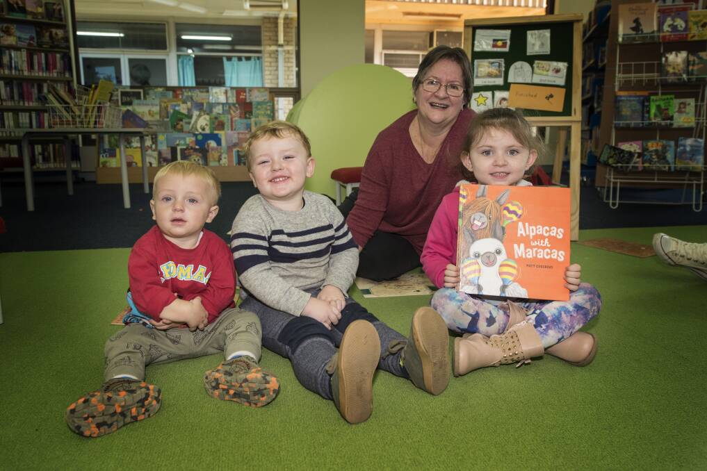STORYTIME: James Allan, Ollie Nash and Addison Dalton enjoy storytime with Cathy Hanly at South Tamworth Library. Photo: Peter Hardin 220519PHA051