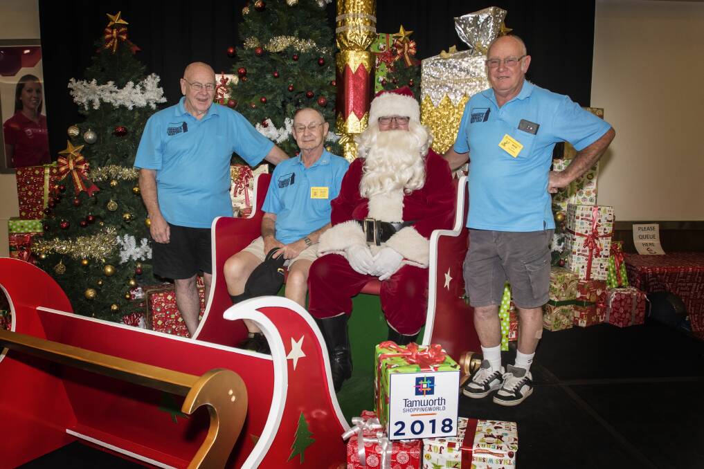 MERRY CHRISTMAS: Men's Shed members Les Thurkettle, Dave Greenland and Rob Hardie with Santa. Photo: Peter Hardin