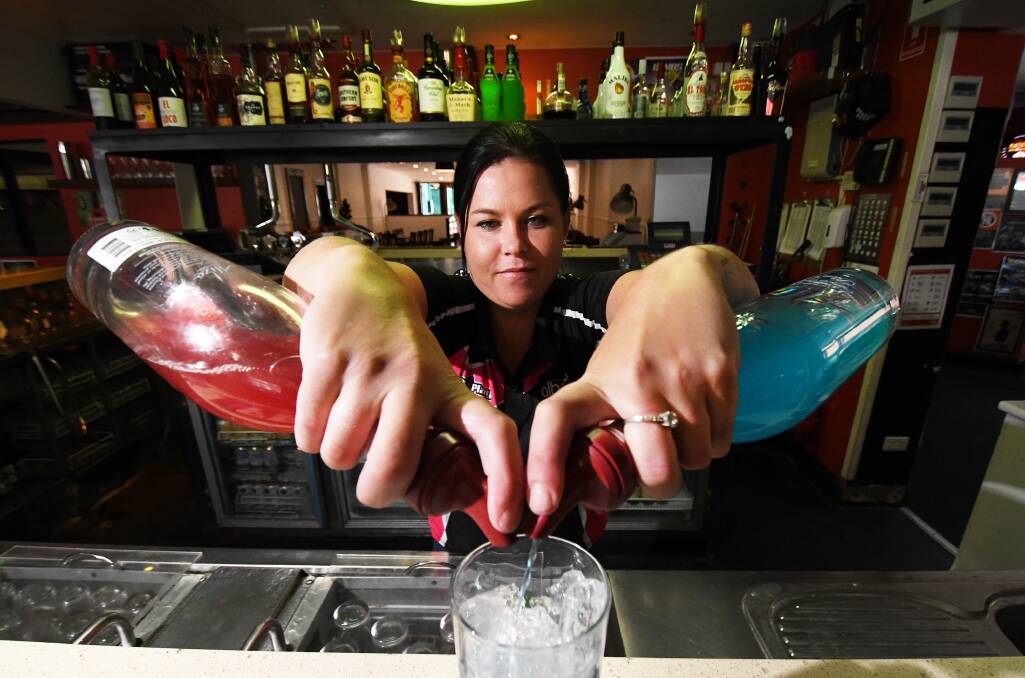 PARTY POUR: The Albert Hotel manager Jodi Edwards prepares for New Year's Eve celebrations. The pub will host six DJ's and a foam party. Photo: Gareth Gardner